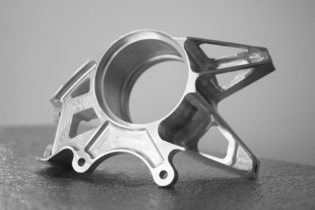 A machined, topology-optimised bracket — a more complex organic shape that still photographs clearly